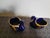 A refined pair of Limoges porcelain swans, crafted in deep cobalt blue and finished with hand‑applied 22 Karat gold gilt...