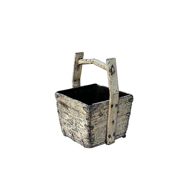 This rustic wooden bucket exudes a timeless, weathered charm, showcasing the beauty of aged craftsmanship. Constructed...