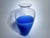 Vintage vase from the 1980s, made by Effetre Murano, in clear glass with a distinctive blue base. The contrast between the...