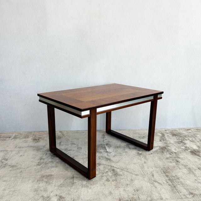 Rosewood table by Möbelfabriks AB Carlsson & Co, Sweden, 1970s. Features richly figured rosewood top with silver trim...