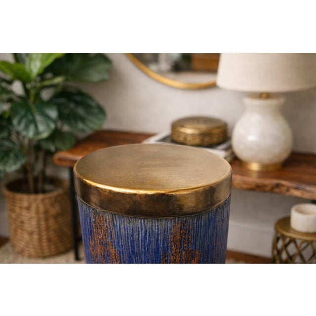 This striking ceramic garden stool features a beautifully crackled gold glazed top paired with a rich cobalt blue body...