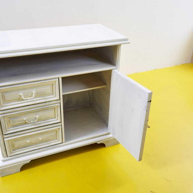 This charming sideboard combines functionality and style, featuring a finely crafted wooden frame. Equipped with three...