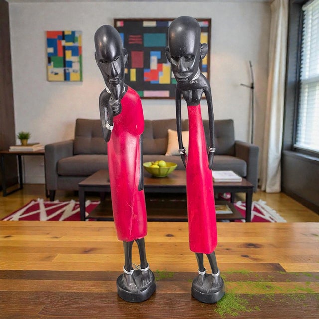 The African Figural Couple Carved Painted Wood Tribal Maasi Statuettes are intricately crafted handmade sculptures that...