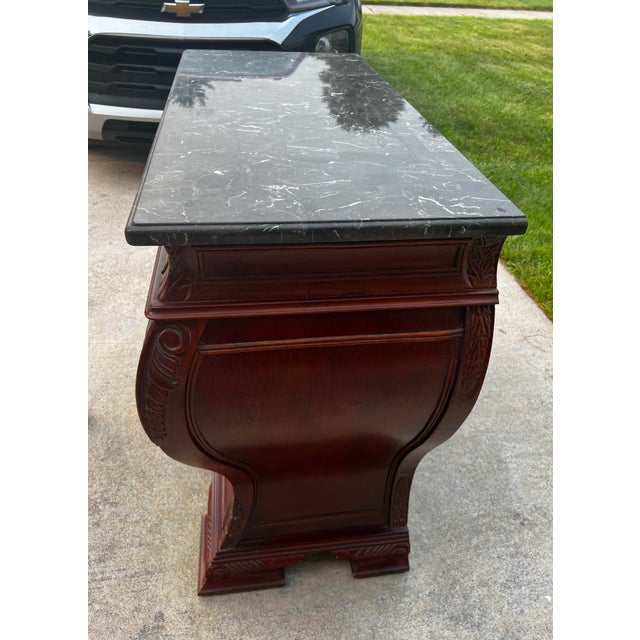 A Bombay® Furniture Co. Marble Top Bombe Chest in a Classic French