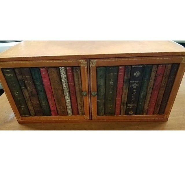 Interesting table with tan-colored leather. two separate boxes with 2 doors on each that open to a single space. Doors are...