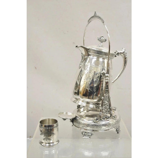 Antique Rogers Smith & Co Silver Plated Victorian Tilting Lemonade Water Pitcher w/ Stand. Item features floral repousse...