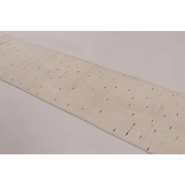 Handwoven in hemp circa 1950–1960, this 3x12 vintage Anatolian runner rug presents a refined, minimalist interpretation of...