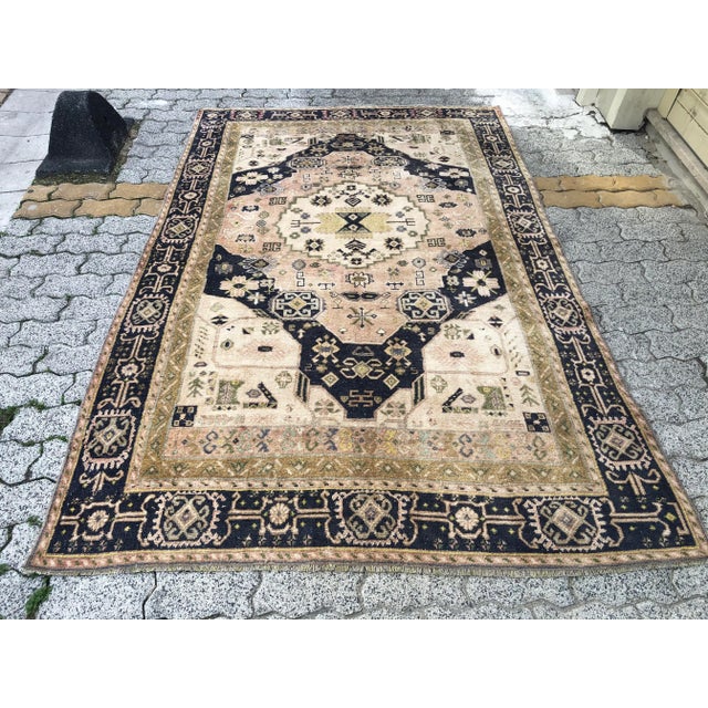 This is a vintage Turkish Oushak rug from the 1960s. The piece was hand-knotted.