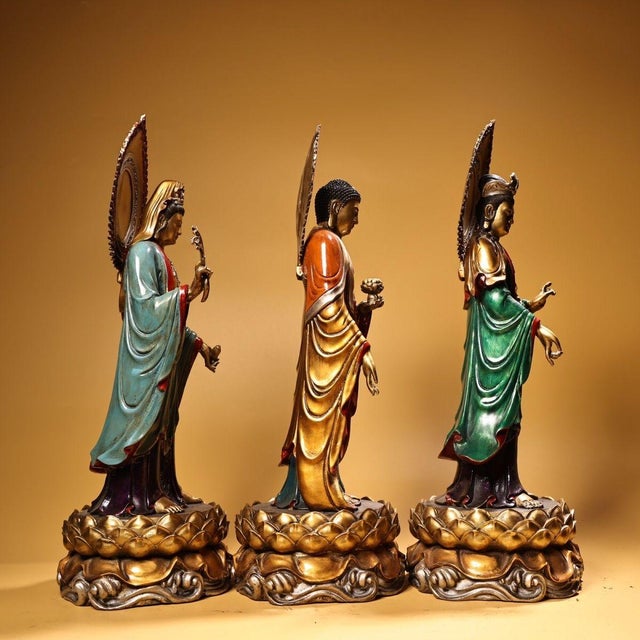 This exceptional set comprises three gilt bronze figures representing the Western Trinity (Amitabha Buddha flanked by the...