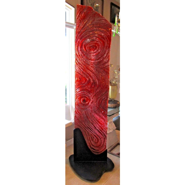 This large 91" flamed red molded glass wave floor sculpture on a steel base is a unique and contemporary piece of art....