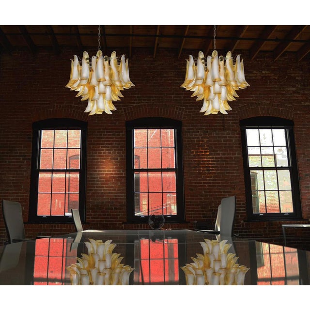 Pair Murano Italian glass chandeliers with 53 fantastic glass petals (clear with amber spot), nickel-plated metal frame....