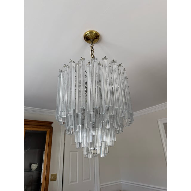 Absolutely stunning mid-20th century vintage Murano glass clear cascading chandelier in the style of Venini Triedri. This...