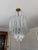 Absolutely stunning mid-20th century vintage Murano glass clear cascading chandelier in the style of Venini Triedri. This...