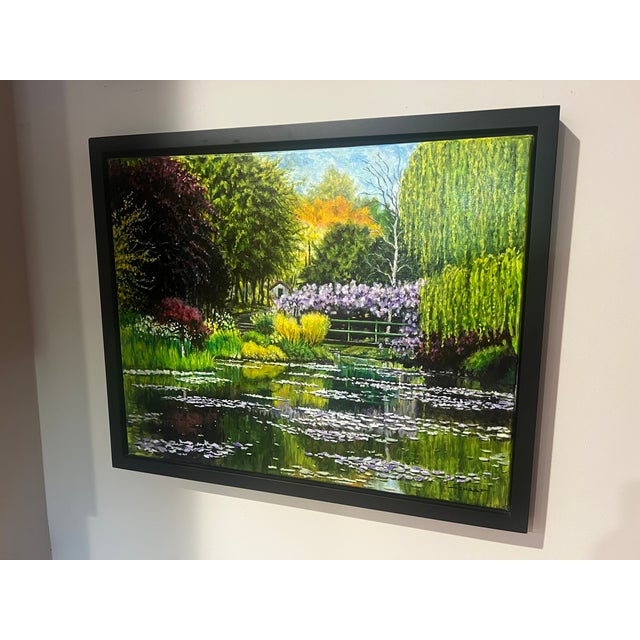 Original oil painting on canvas by Steve Schaaf featuring a tranquil garden pond filled with blooming water lilies,...