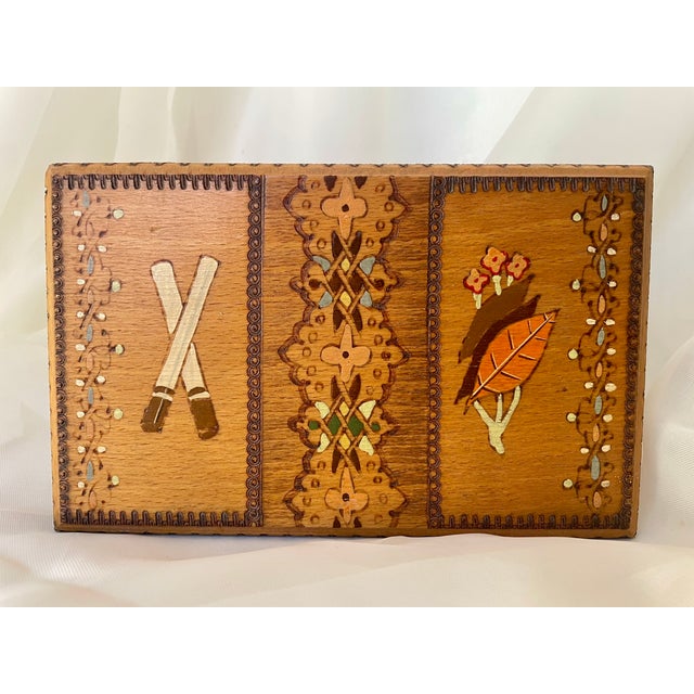 Vintage wooden cigarette box, hand-painted and embellished with pyrography. When the lid is opened, an internal mechanism...
