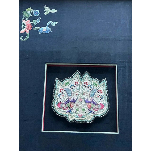 A beautiful antique embroidered purse from China, circa 19th century Qing dynasty, artistically displayed in a giltwood...