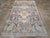 This early 20th-century Persian Bakhtiari carpet presents a richly detailed tribal composition across a deep blue field....