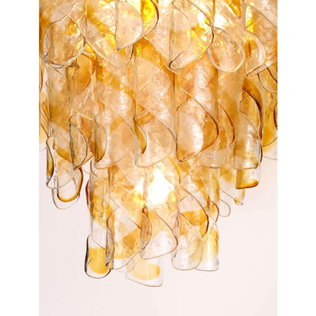 A spectacular Italian Mazzega multi-tier chandelier featuring cascading layers of hand-blown amber and clear glass. Each...