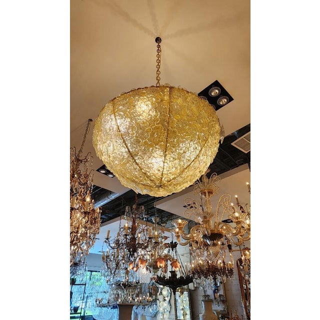 This listing features a custom Murano style glass chandelier, with beautiful transparent glass flowers that glow with a...