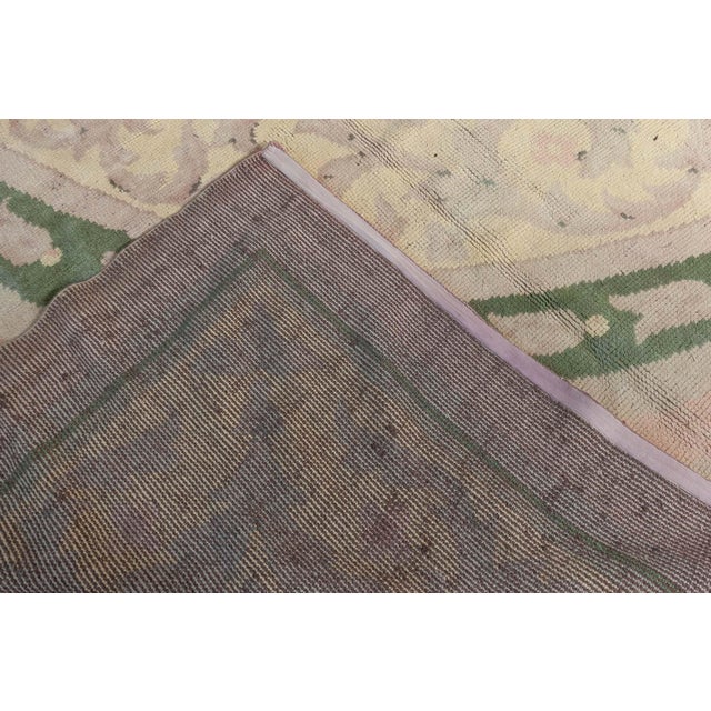 A masterful example of French decorative arts, this large vintage Savonnerie rug from the 1920s radiates refined...