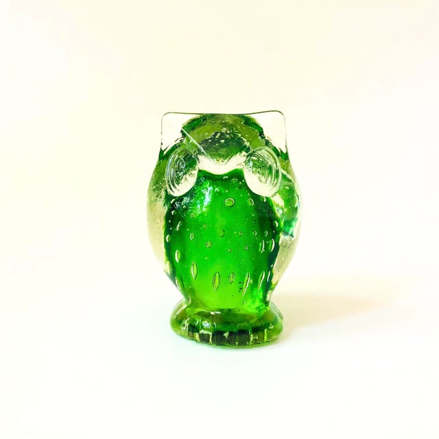 A vintage art glass owl. Vibrant green interior encased in clear glass with lovely controlled bubbles inside.