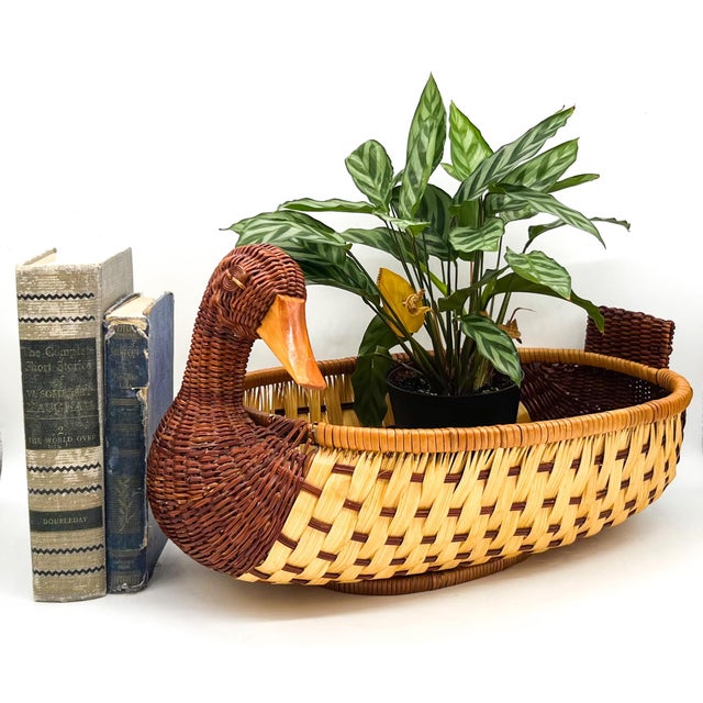 Whimsical vintage wicker basket formed as a graceful duck with an elongated neck and sculptural woven head. The oval body...