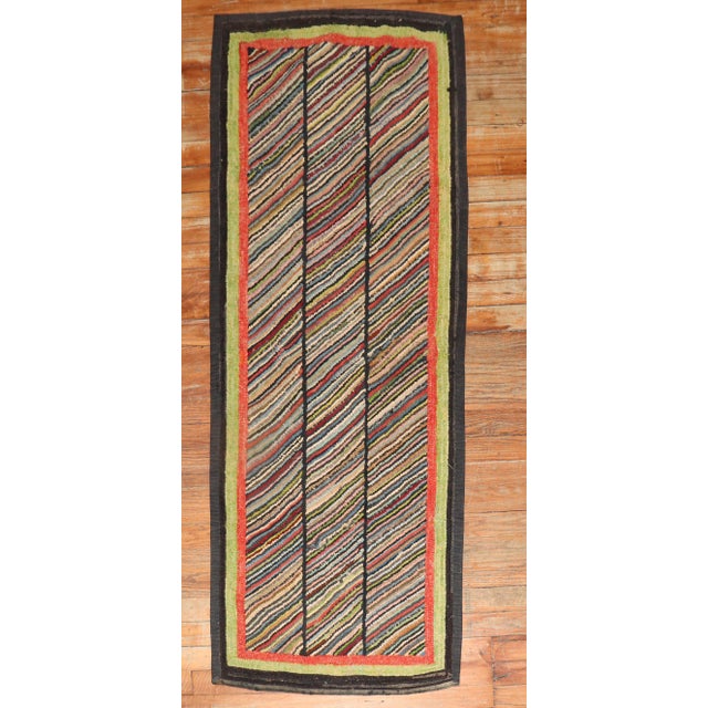 A handmade one-of-a-kind American hooked rug from the 2nd quarter of the 20th century. Measures: 2' x 5'1''.