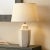 This handcrafted ceramic lamp accentuates its lines with hand-painted piping. The white-on-white look continues with a...