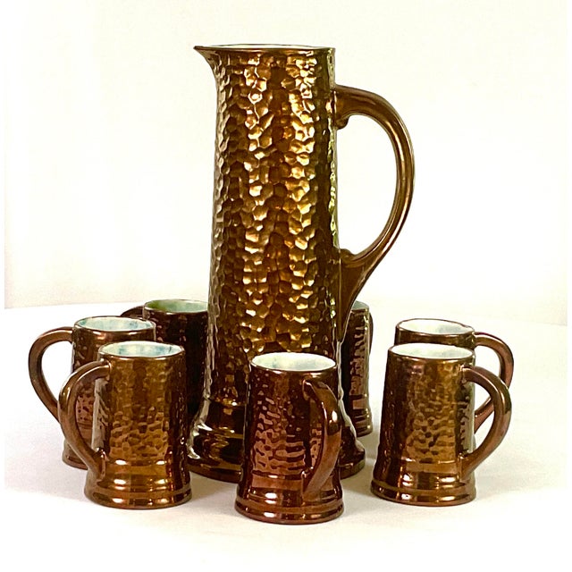 1930s Handcrafted, Artisan – Ceramic Large, Pitcher, and Eight Tankards-in a Hammered Copper Lusterware Finish - Set of 9 For Sale - Image 9 of 11