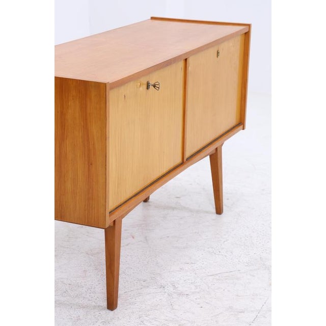 Beautiful mid-century chest of drawers from the 1960s High-quality workmanship • 1 key • 2 solid wood shelves • 2 drop-...