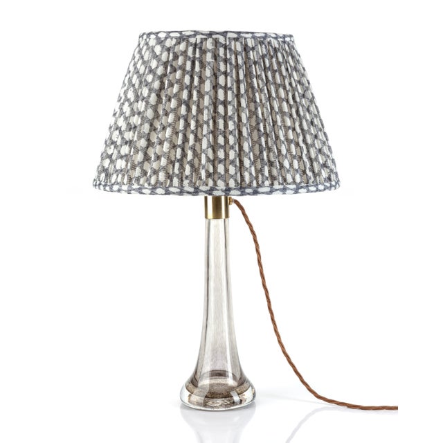 Fermoie lampshades are artisanal, British-made lighting fixtures renowned for their rich, textured fabrics, soft geometric...
