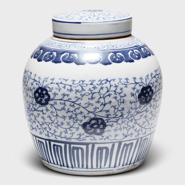 This round, porcelain storage jar is brightly glazed in the classic blue-and-white manner with allover pattern of trailing...