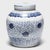 This round, porcelain storage jar is brightly glazed in the classic blue-and-white manner with allover pattern of trailing...