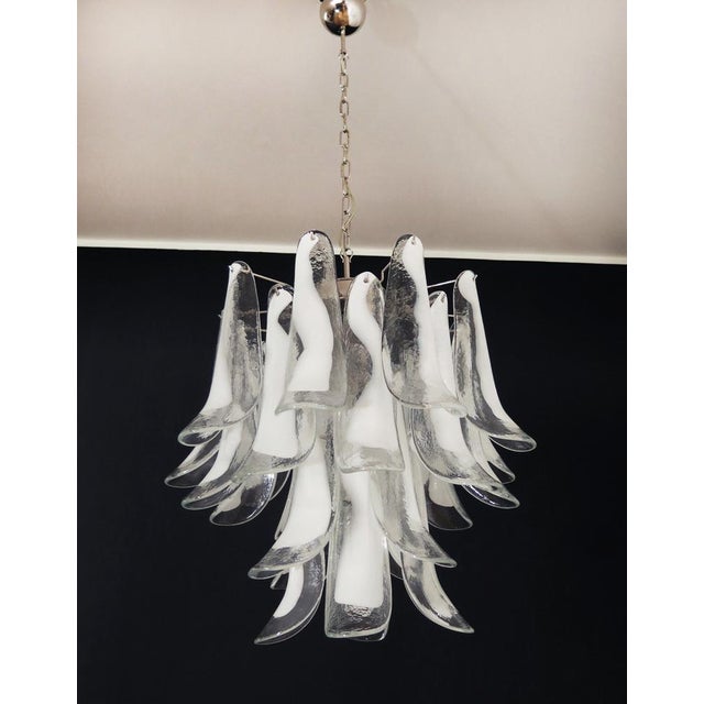 Italian vintage Murano chandelier made by 26 glass petals (trasparent and white “lattimo”) in a chrome frame. Period: late...