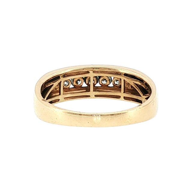 A refined late-20th-century 14k gold wedding ring featuring five brilliant-cut white diamonds, totaling 0.5 carats. The...