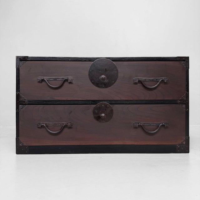A low Japanese tansu with two spacious drawers and a warm, dark brown wood patina. Dimensions: height 49 cm, width 86 cm,...