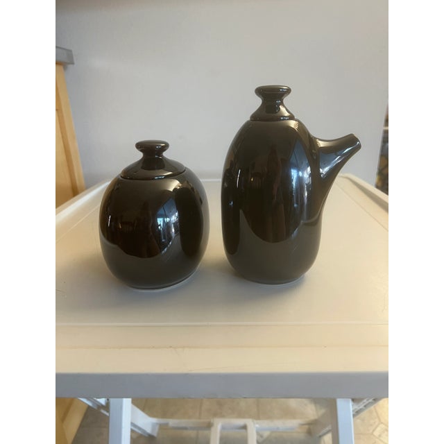 20th Century Glossy Black ceramic lidded sugar and creamer set by Lindt-Stymeist Discontinued. Creamer with lid is 6” tall...