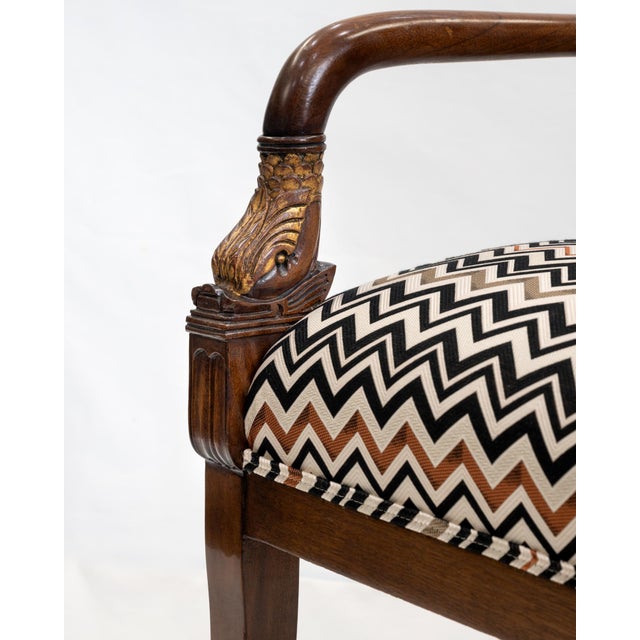 Classic wooden armchairs with gold leaf accents. Iconic black, white, rust zig zag patterned fabric. Missoni Style. Set