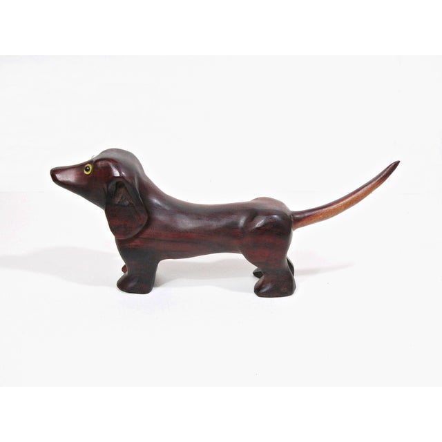 A wonderfully sculptural vintage carved hardwood dachshund, full of charm and character, with an elongated silhouette,...