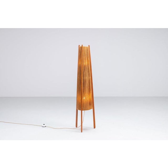 A beautiful and sculptural tripod floor lamp manufactured by Temde in Switzerland during the 1960s. The lamp features a...