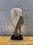 A striking vintage postmodern abstract sculpture, hand carved from stone and mounted on a dramatic stacked black and clear...