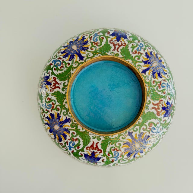 Cloisonné enamel circular box with cover and brass edges. Nice color with a white ground, forest green and navy. Blue...