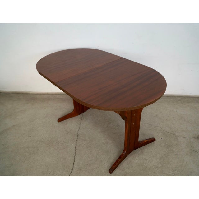 1960's Mid Century Danish Modern oval dining table for sale. It's a trestle dining table that has an oval shape, and has...
