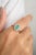 Discover elegance with our 18K white gold oval cut emerald halo diamond ring. This stunning piece features a vibrant...