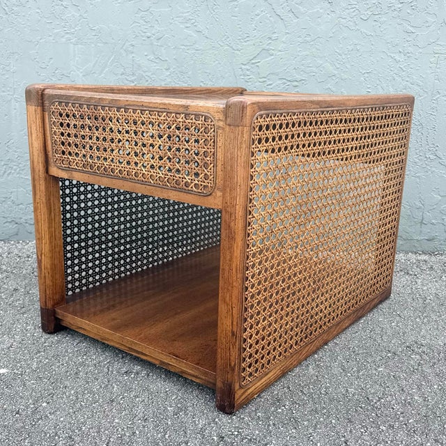 A beautifully crafted vintage boho chic side table, featuring warm oak construction adorned with finely woven cane...