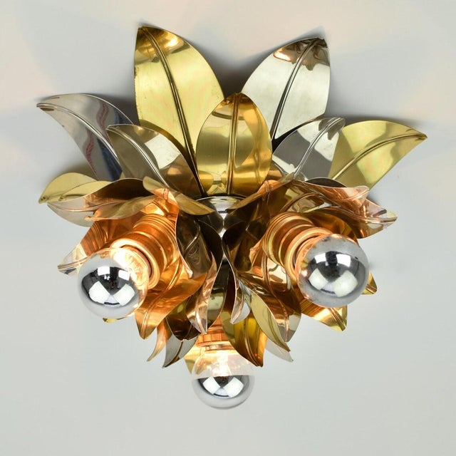 Stunning mid century flush mount, made around the 1960s. This light is made from aluminum and brass leaves, and has a...