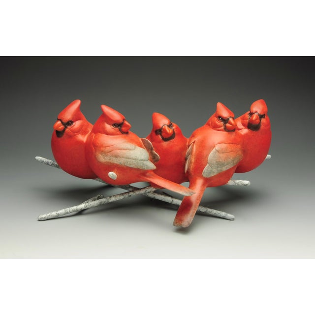 House of Cards features a dynamic arrangement of six vibrant red cardinals perched on a stylized branch. The smooth,...