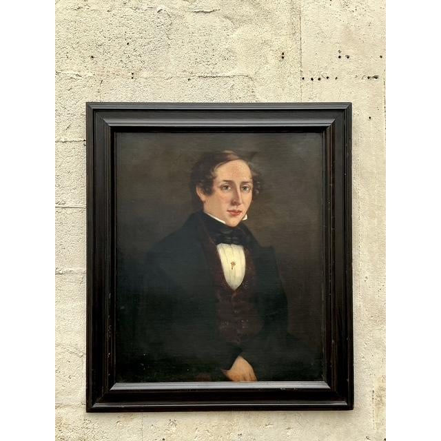 Infuse your space with the distinguished presence and captivating allure of this antique original oil portrait on canvas....