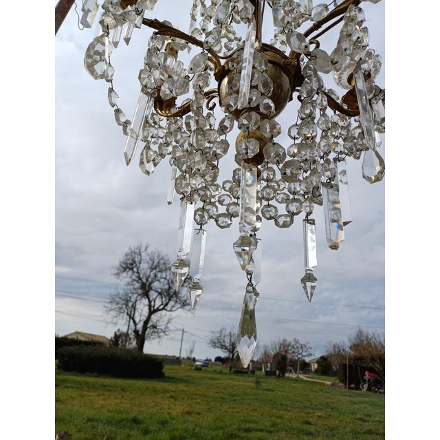 19th Century Crystal Chandelier, 1920s, in Worn conditions. Designed 1920 to 1949 European Plug (up to 250V).The wiring of...