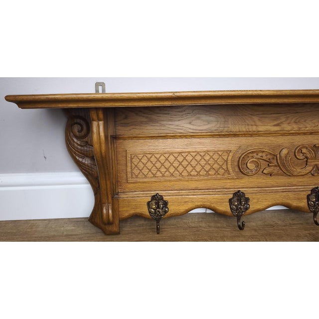A striking large Vintage French coat hanger featuring beautifully carved detailing and a warm oak finish that enhances its...